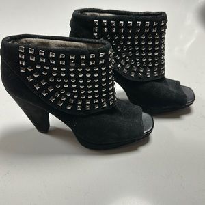 Black peep toe suede booties with studs.